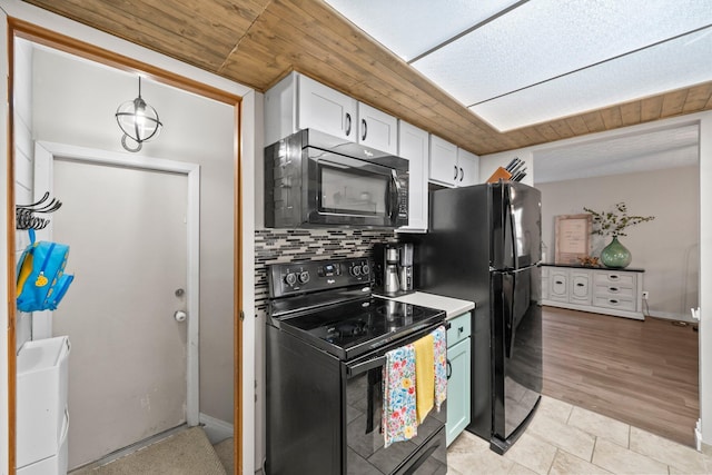 2387 Sutter Pkwy, Dublin, OH 43016 - kitchen with black appliances, white cabinetry, and decorative backsplash