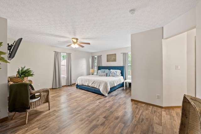 2387 Sutter Pkwy, Dublin, OH 43016 - bedroom featuring wood finished floors, a textured ceiling, and a ceiling fan