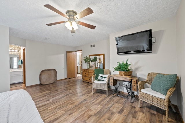 2387 Sutter Pkwy, Dublin, OH 43016 - bedroom featuring wood finished floors, a textured ceiling, a ceiling fan, and ensuite bathroom