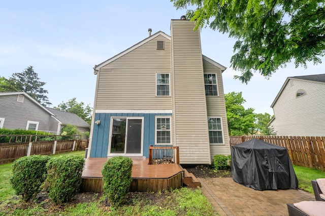 2387 Sutter Pkwy, Dublin, OH 43016 - back of property with a deck, a fenced backyard, a chimney, and a patio