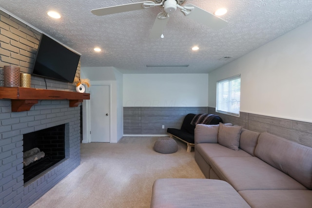 5081 Mengel Ln, Hilliard, OH 43026 - living area with carpet floors, a fireplace, wainscoting, a textured ceiling, and a ceiling fan