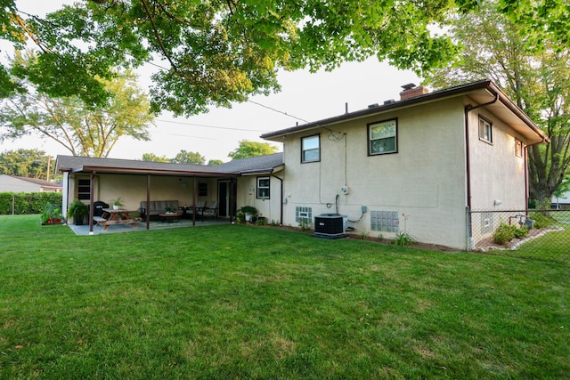 5081 Mengel Ln, Hilliard, OH 43026 - rear view of house with a chimney, a patio, an outdoor hangout area, and stucco siding