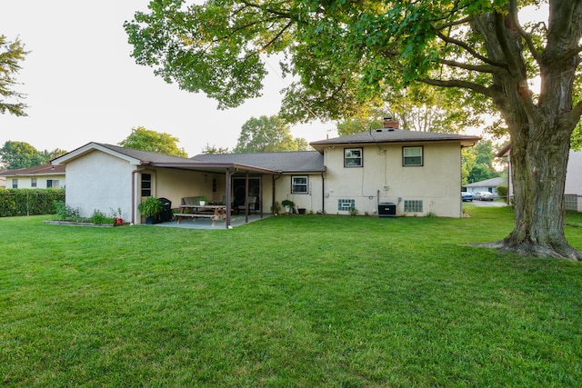 5081 Mengel Ln, Hilliard, OH 43026 - rear view of property featuring a patio area, a yard, and stucco siding