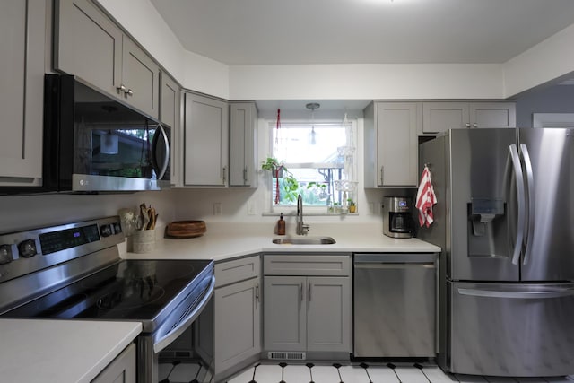 5081 Mengel Ln, Hilliard, OH 43026 - kitchen featuring appliances with stainless steel finishes, gray cabinetry, and light countertops