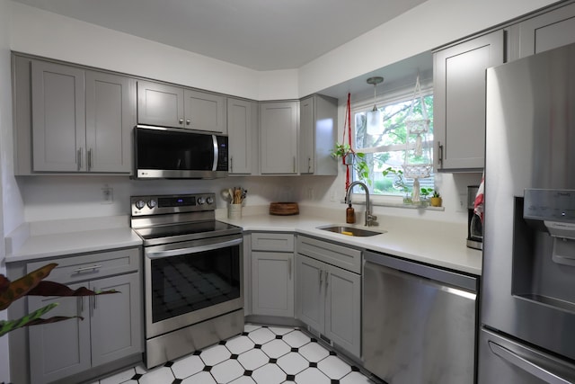 5081 Mengel Ln, Hilliard, OH 43026 - kitchen with stainless steel appliances, gray cabinetry, light countertops, and light floors