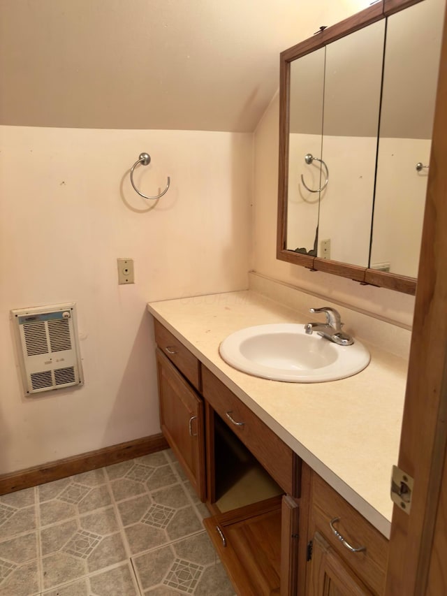 3660 Watt Rd, Columbus, OH 43230 - bathroom featuring heating unit, vaulted ceiling, and vanity