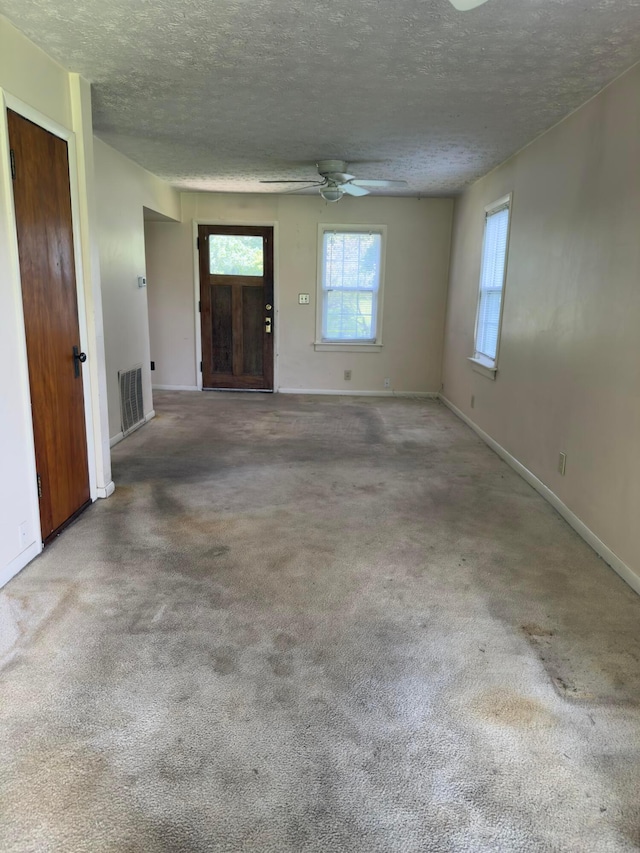 3660 Watt Rd, Columbus, OH 43230 - unfurnished living room featuring a ceiling fan, a textured ceiling, and carpet