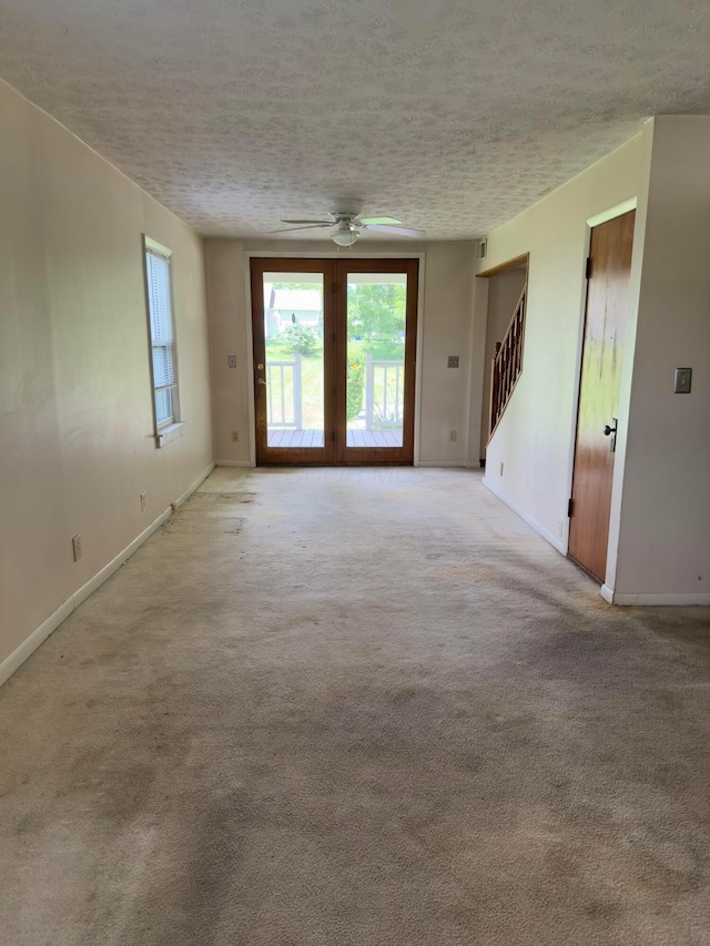 3660 Watt Rd, Columbus, OH 43230 - empty room featuring a textured ceiling, a ceiling fan, light colored carpet, and stairs