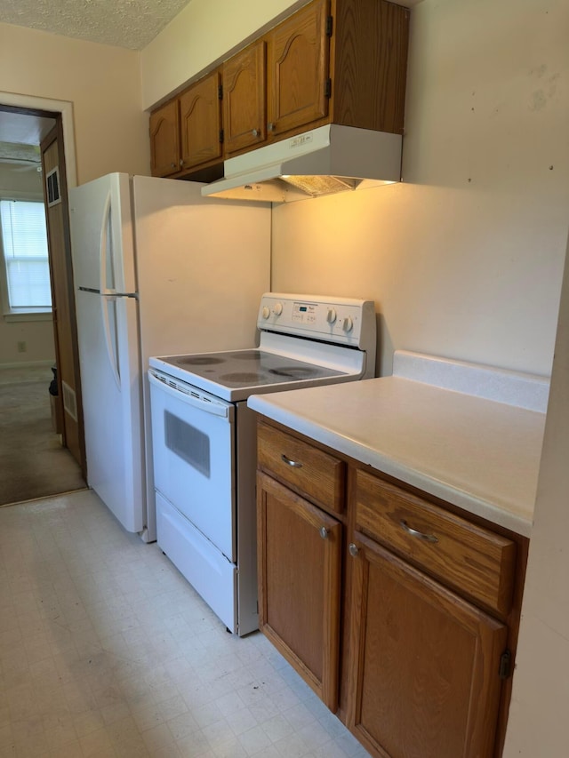 3660 Watt Rd, Columbus, OH 43230 - kitchen featuring electric range, brown cabinetry, under cabinet range hood, light countertops, and light floors