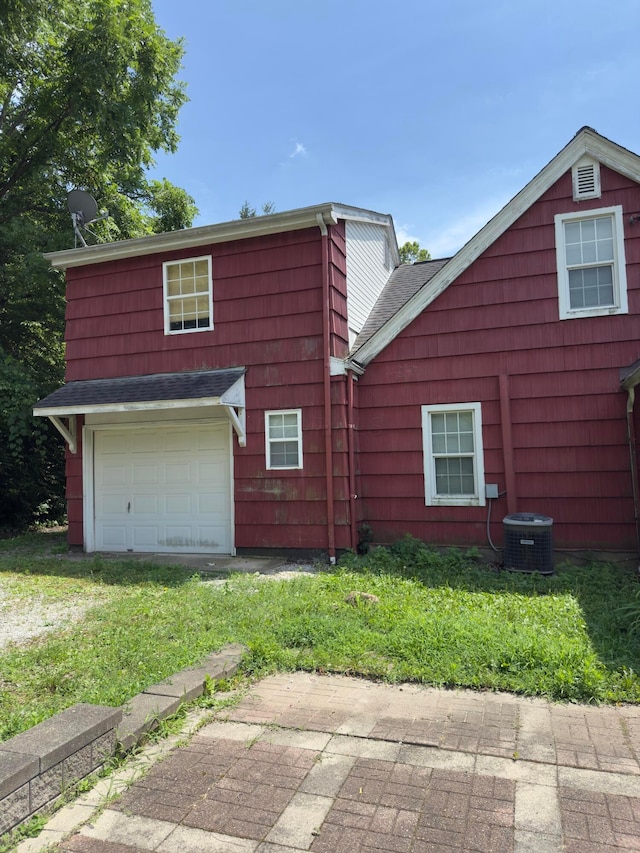 3660 Watt Rd, Columbus, OH 43230 - view of property exterior featuring a lawn, a shingled roof, and driveway