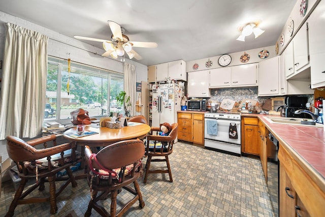 3750 Dresden St, Columbus, OH 43224 - kitchen with white appliances, tile countertops, ceiling fan, tasteful backsplash, and white cabinetry