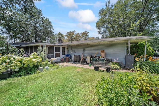 3750 Dresden St, Columbus, OH 43224 - back of house featuring a sunroom, a yard, and a patio