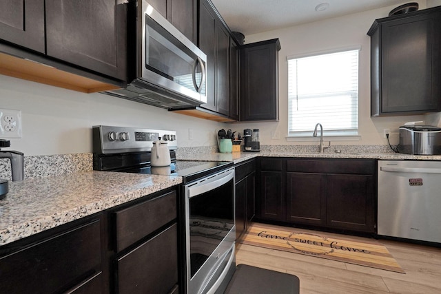 322 Honeysuckle St, South Bloomfield, OH 43103 - kitchen with appliances with stainless steel finishes, light wood-style flooring, and light stone counters