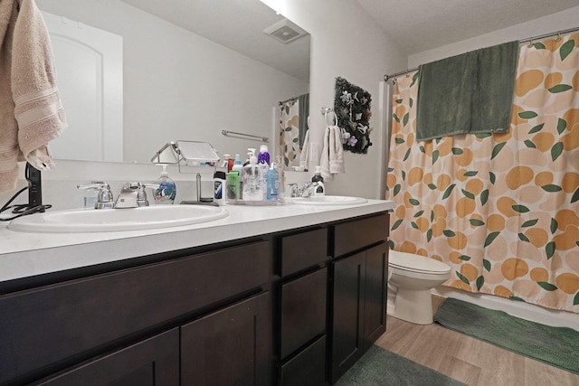 322 Honeysuckle St, South Bloomfield, OH 43103 - full bathroom with double vanity, wood finished floors, and a shower with curtain