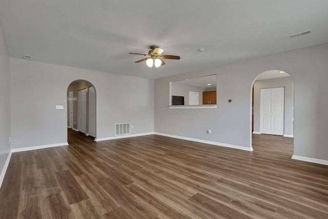 5512 Old Coble St, Canal Winchester, OH 43110 - unfurnished living room with arched walkways, a ceiling fan, and dark wood-type flooring