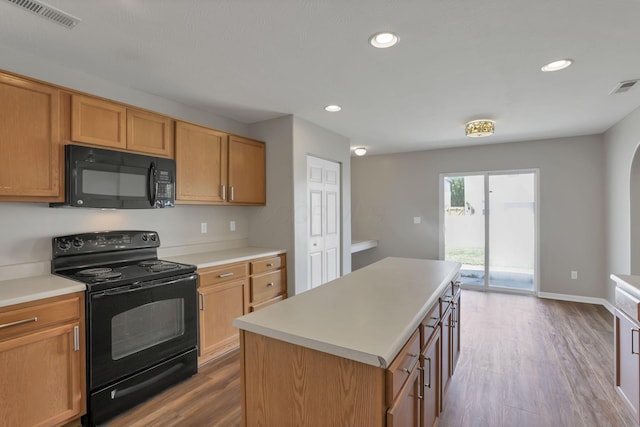 5512 Old Coble St, Canal Winchester, OH 43110 - kitchen with black appliances, dark wood-type flooring, light countertops, a kitchen island, and recessed lighting