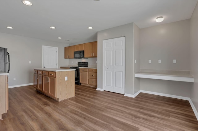 5512 Old Coble St, Canal Winchester, OH 43110 - kitchen with black appliances, light countertops, wood finished floors, a center island, and recessed lighting