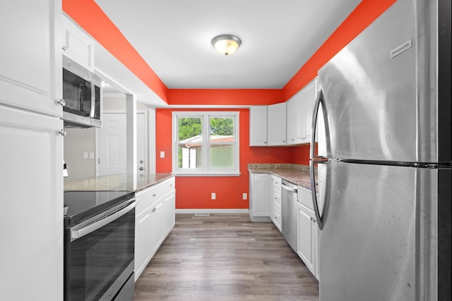 3851 Security Dr, Grove City, OH 43123 - kitchen with appliances with stainless steel finishes, white cabinets, and light wood-style floors