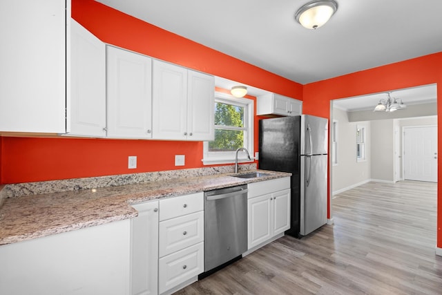 3851 Security Dr, Grove City, OH 43123 - kitchen featuring stainless steel appliances, white cabinets, a chandelier, light wood-type flooring, and light stone countertops