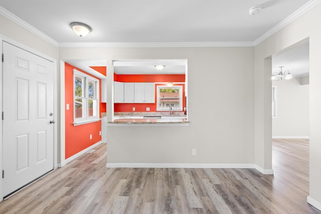3851 Security Dr, Grove City, OH 43123 - kitchen with light wood-style floors, crown molding, healthy amount of natural light, and white cabinetry