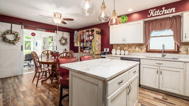 405 Meadowland Dr, Newark, OH 43055 - kitchen with ceiling fan, light wood-style floors, decorative backsplash, a center island, and hanging light fixtures
