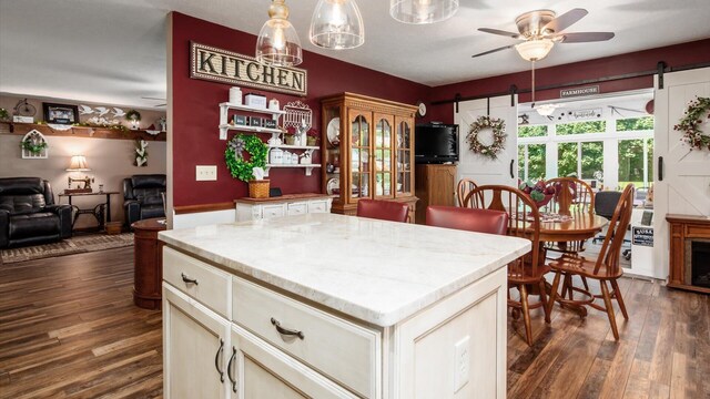 405 Meadowland Dr, Newark, OH 43055 - kitchen featuring a barn door, dark wood-type flooring, a ceiling fan, and open floor plan