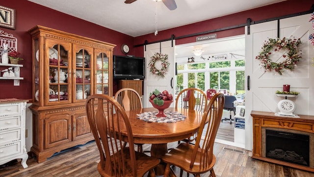 405 Meadowland Dr, Newark, OH 43055 - dining area with a barn door, wood finished floors, and ceiling fan