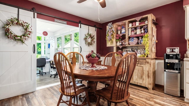 405 Meadowland Dr, Newark, OH 43055 - dining area with a barn door, light wood-style floors, and a ceiling fan