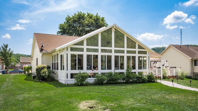 405 Meadowland Dr, Newark, OH 43055 - back of property featuring a lawn, a shingled roof, and a sunroom