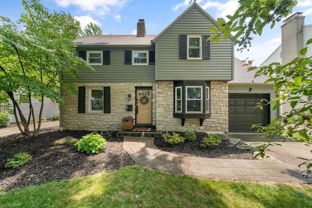67 Aldrich Rd, Columbus, OH 43214 - view of front of property featuring a garage, stone siding, a chimney, driveway, and a shingled roof