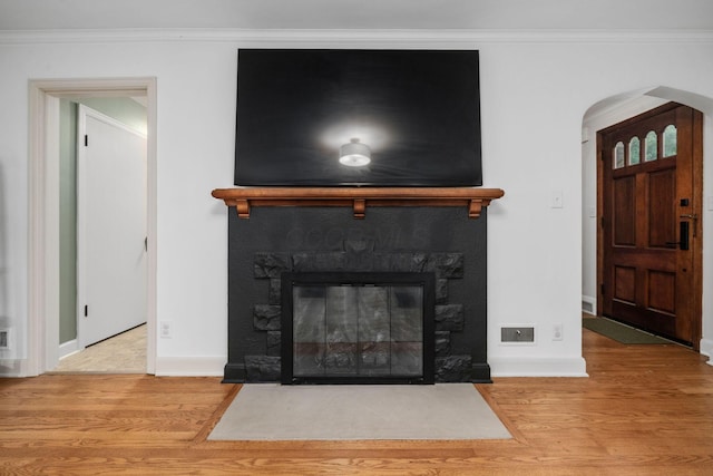 67 Aldrich Rd, Columbus, OH 43214 - detailed view of wood finished floors, a glass covered fireplace, ornamental molding, and arched walkways