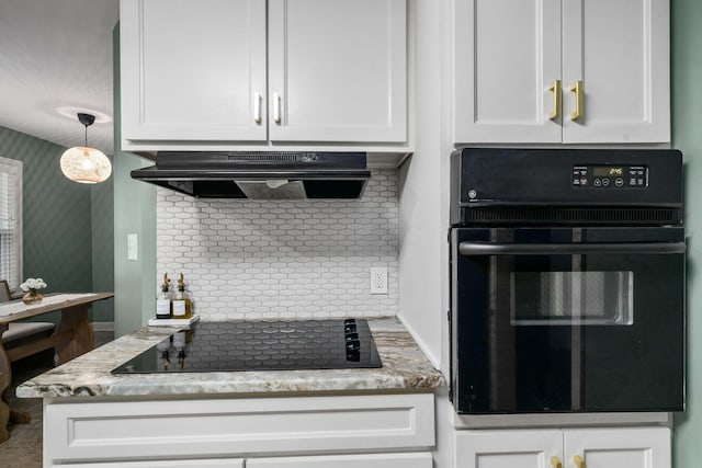 67 Aldrich Rd, Columbus, OH 43214 - kitchen with black appliances, range hood, decorative backsplash, white cabinetry, and light stone counters