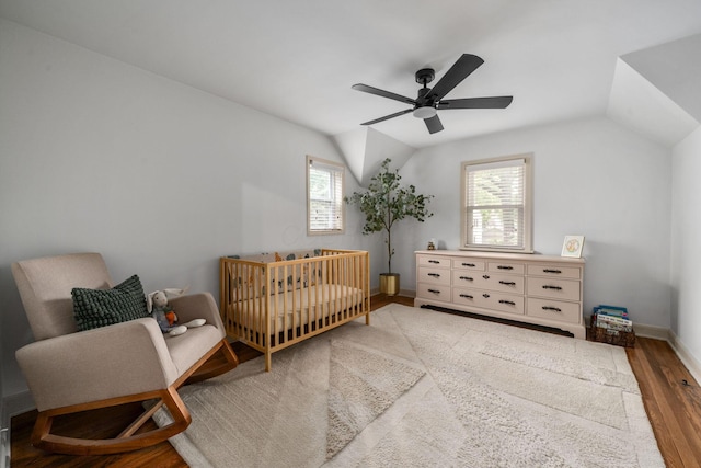 67 Aldrich Rd, Columbus, OH 43214 - bedroom featuring wood finished floors, lofted ceiling, a crib, and a ceiling fan