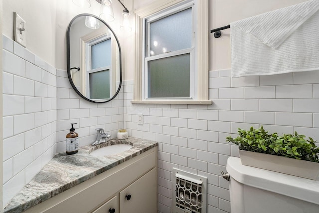 67 Aldrich Rd, Columbus, OH 43214 - half bathroom featuring vanity, tile walls, and backsplash