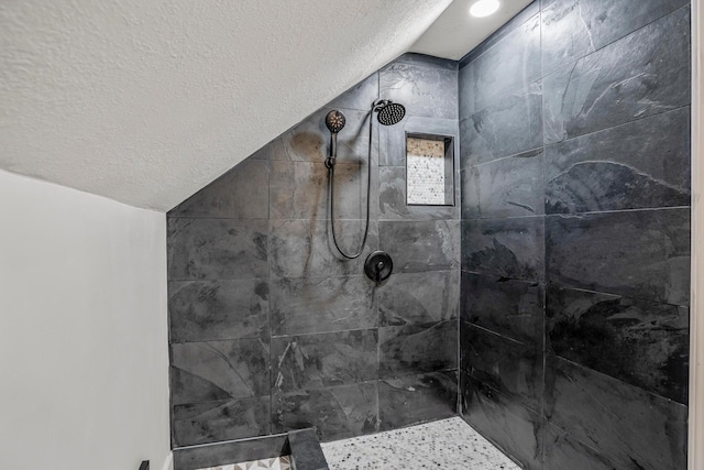 287 S Roys Ave, Columbus, OH 43204 - full bathroom with a textured ceiling, lofted ceiling, and tiled shower