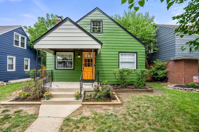 287 S Roys Ave, Columbus, OH 43204 - view of front of home featuring covered porch, a front yard, and a chimney