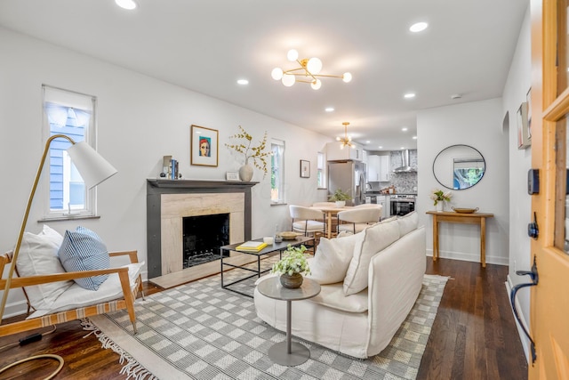 287 S Roys Ave, Columbus, OH 43204 - living room featuring a premium fireplace, a chandelier, recessed lighting, and wood finished floors
