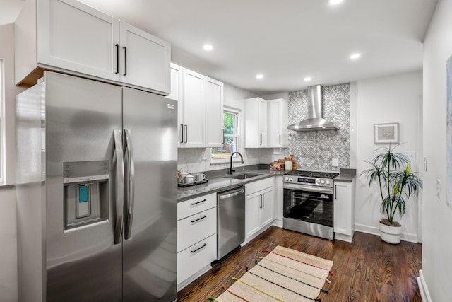 287 S Roys Ave, Columbus, OH 43204 - kitchen with stainless steel appliances, wall chimney range hood, dark countertops, backsplash, and dark wood-style floors