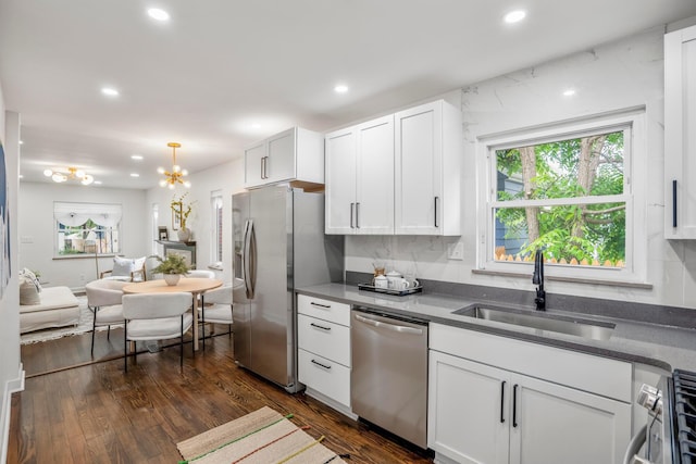 287 S Roys Ave, Columbus, OH 43204 - kitchen with stainless steel appliances, recessed lighting, dark wood finished floors, white cabinets, and a chandelier