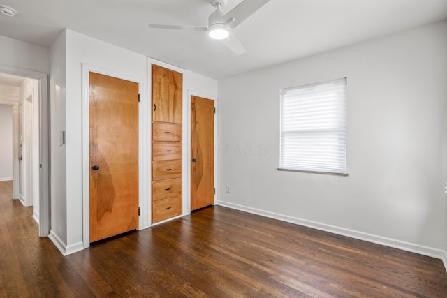 287 S Roys Ave, Columbus, OH 43204 - unfurnished bedroom featuring dark wood-style flooring, ceiling fan, and a closet
