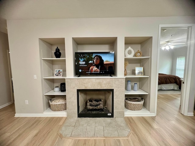 6090 Sowerby Ln, Westerville, OH 43081 - detailed view of wood finished floors, built in features, a tile fireplace, and a ceiling fan