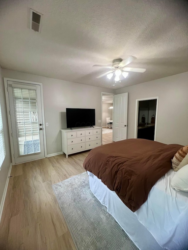 6090 Sowerby Ln, Westerville, OH 43081 - bedroom featuring light wood finished floors, a textured ceiling, and ceiling fan