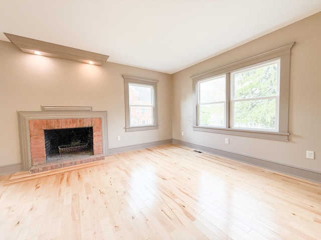 69 N Cherry St, Mount Gilead, OH 43338 - unfurnished living room with a fireplace, healthy amount of natural light, and wood finished floors