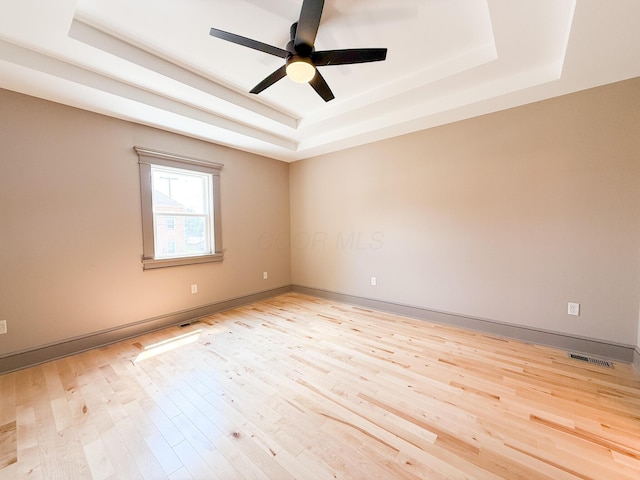 69 N Cherry St, Mount Gilead, OH 43338 - spare room featuring a raised ceiling, light wood-type flooring, and ceiling fan