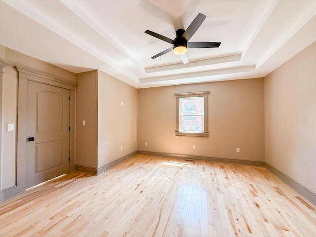 69 N Cherry St, Mount Gilead, OH 43338 - spare room featuring a raised ceiling, light wood-style flooring, and ceiling fan