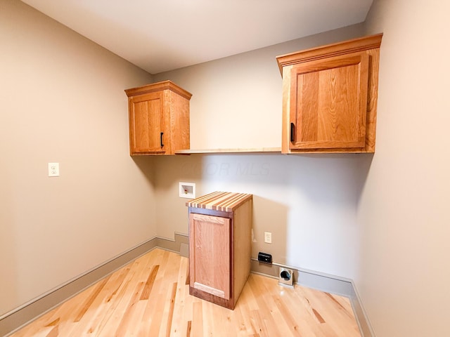 69 N Cherry St, Mount Gilead, OH 43338 - laundry area featuring light wood finished floors, hookup for an electric dryer, cabinet space, and hookup for a washing machine