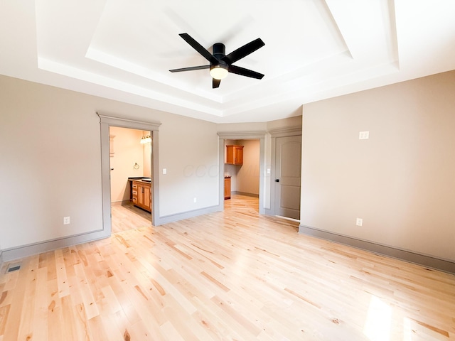 69 N Cherry St, Mount Gilead, OH 43338 - empty room with a tray ceiling, a ceiling fan, and light wood-style flooring