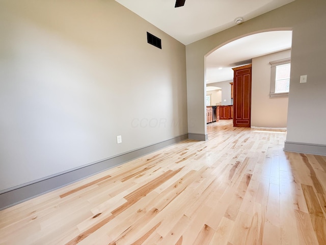 69 N Cherry St, Mount Gilead, OH 43338 - empty room with arched walkways, light wood-style flooring, ceiling fan, and a smoke detector