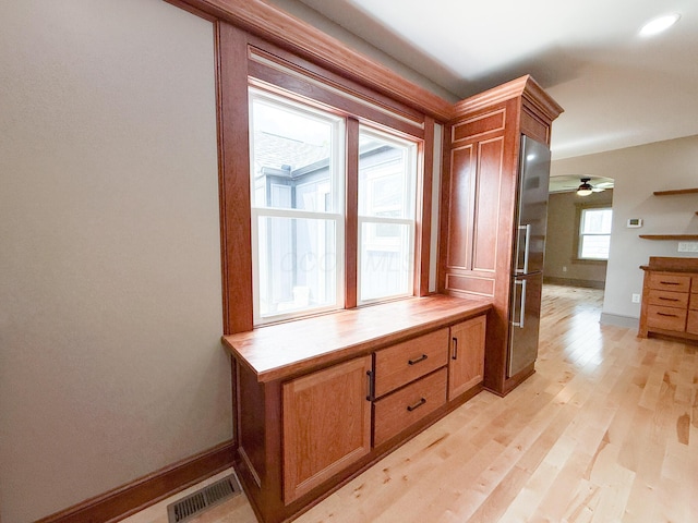 69 N Cherry St, Mount Gilead, OH 43338 - kitchen featuring high end refrigerator, brown cabinets, light wood finished floors, light countertops, and a ceiling fan