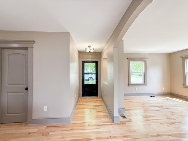 69 N Cherry St, Mount Gilead, OH 43338 - foyer entrance with healthy amount of natural light, light wood-type flooring, and arched walkways